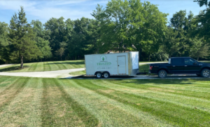 Truck parked on driveaway with a beautiful freshly mowed lawn around it